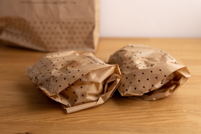 Two donuts in paper bags