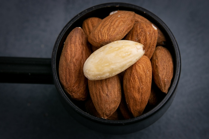 Unpeeled almonds in a scopp