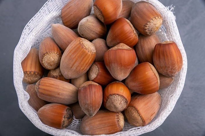 Unshelled hazelnuts in a mesh bag