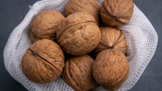 Unshelled walnuts in a mesh bag