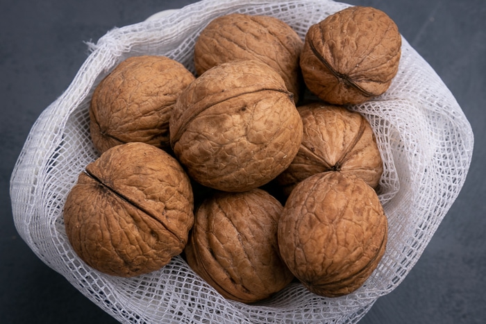 Unshelled walnuts in a mesh bag